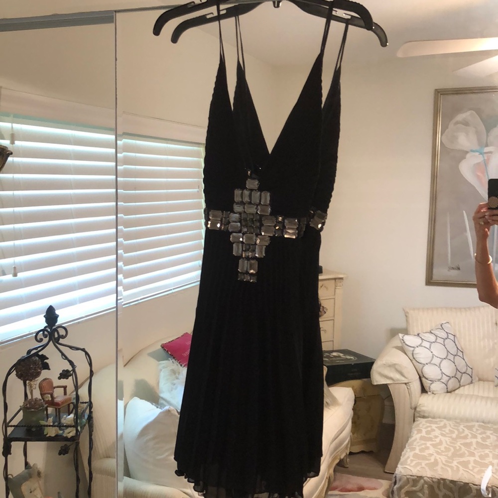 Black pleated cocktail dress with stones, new with tags.